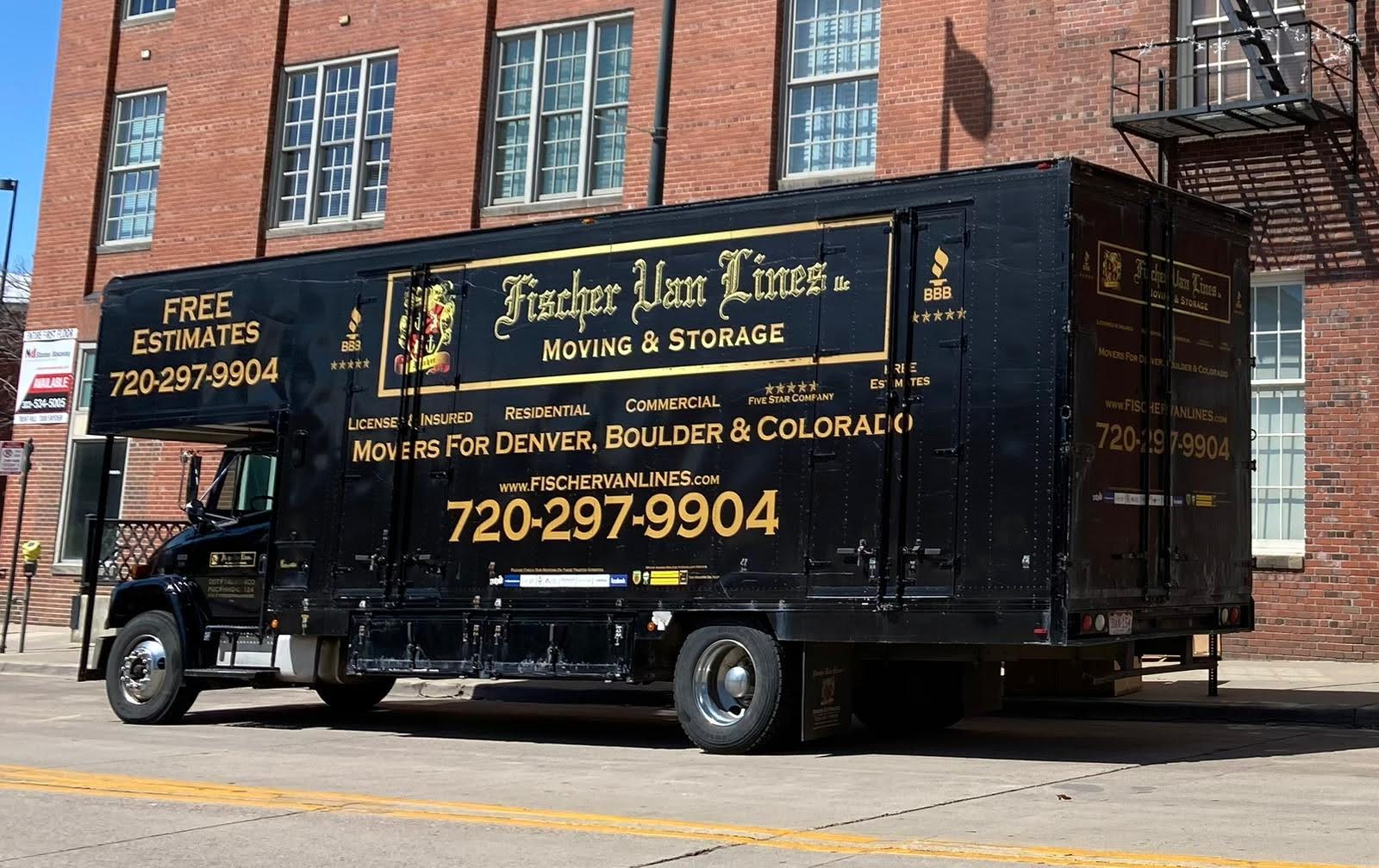 Fischer Van Lines moving truck parked outside a brick commercial building