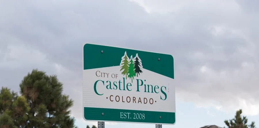 City of Castle Pines, Colorado sign (established 2008) beside pine trees