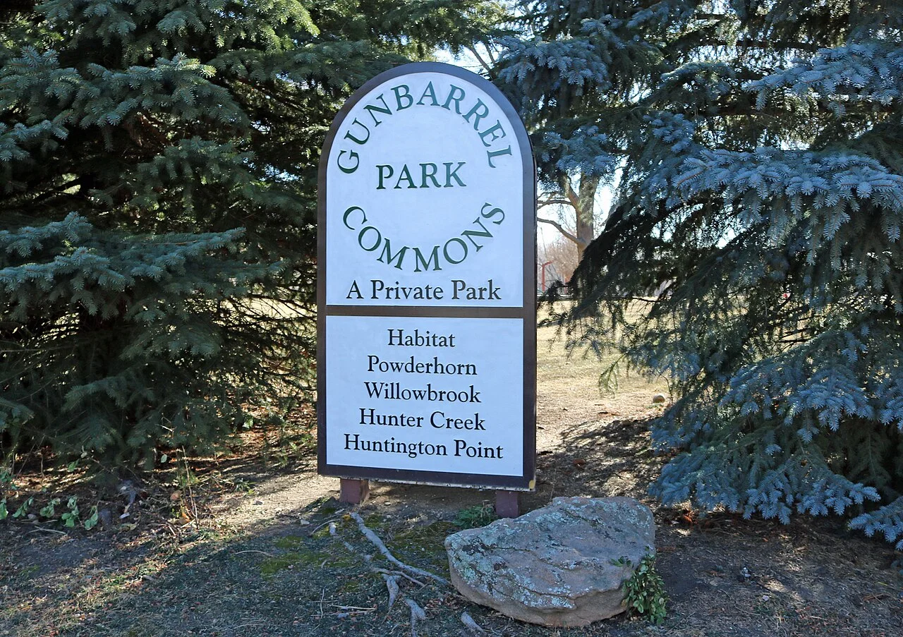Gunbarrel Park Commons sign among blue spruce trees in Gunbarrel, Colorado